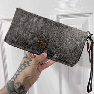 STS Ranchwear Classic Cowhide Clutch with a removable wristlet strap.